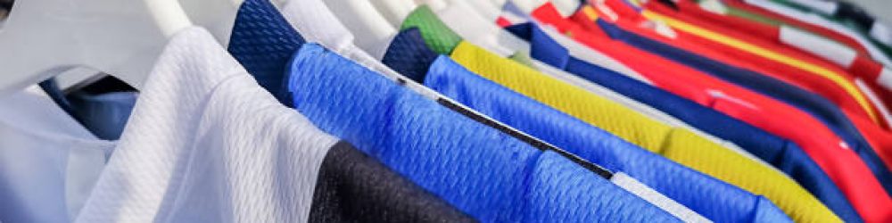 Colorful sports team shirts hanging at clothes rails